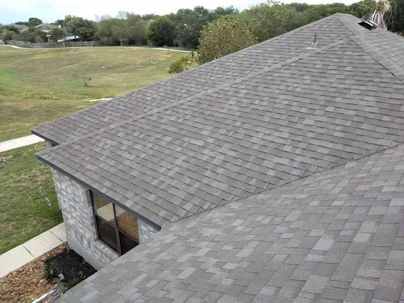 Close up of a residential roof with gray shingles recently installed by Juarez Contracting & Innovation LLC