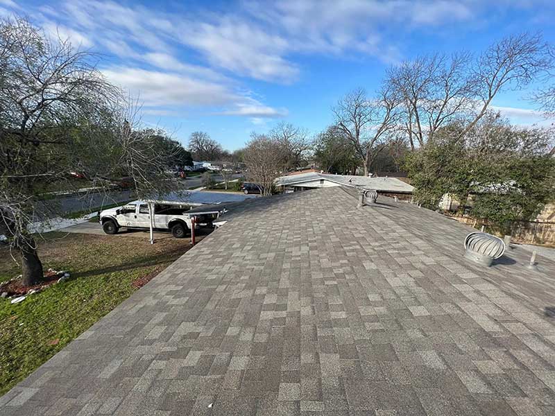 Top and close up view of a residential roof with new gray shingles installed by Juarez Contracting & Innovation LLC