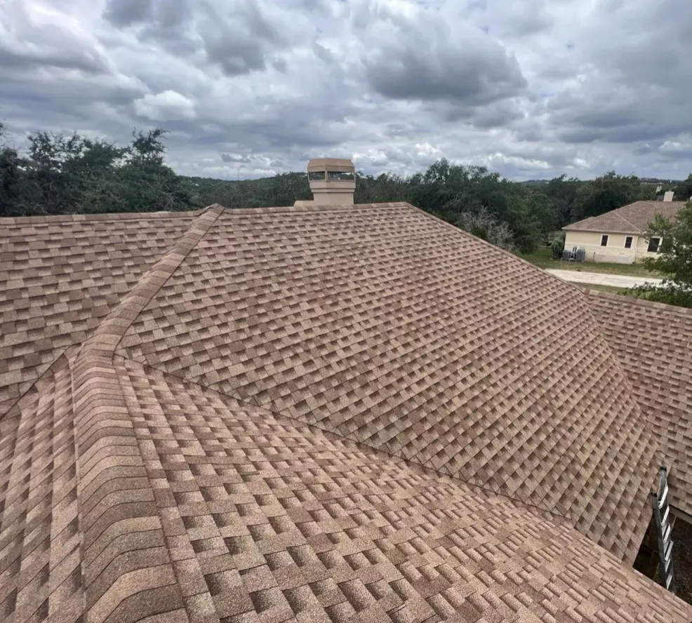 Top and close up view of a residential roof with new gray shingles installed by Juarez Contracting & Innovation LLC